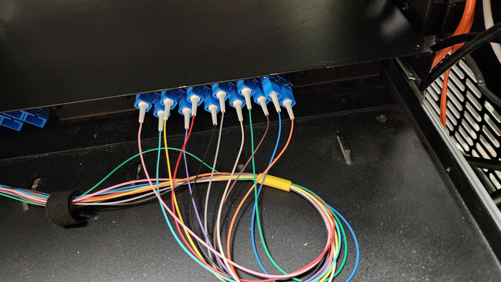 Color-coded fiber strands in a splice enclosure