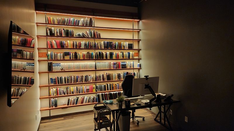 A library wall with LED shelf lighting