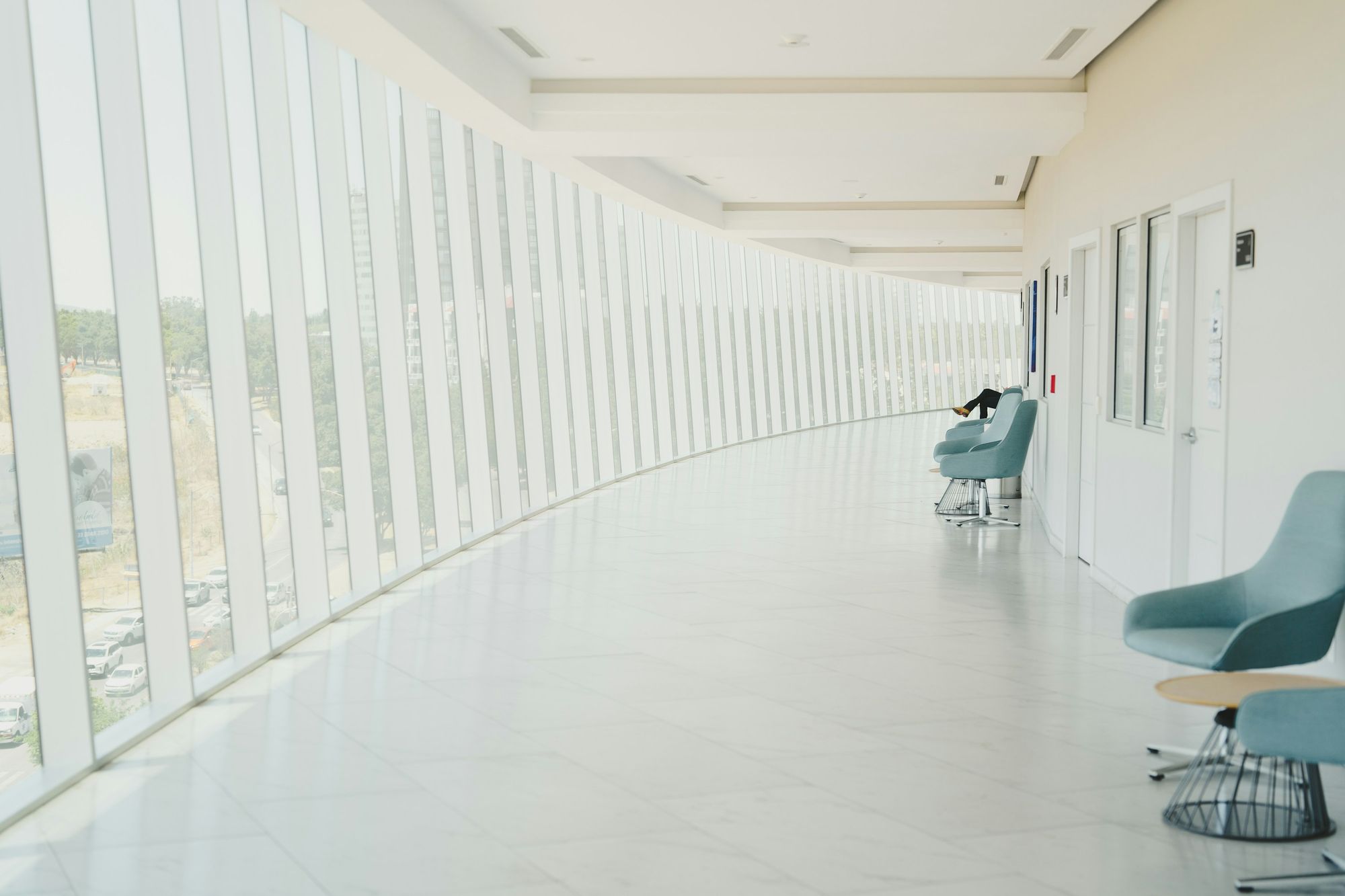 A bright, quiet hallway with a row of chairs