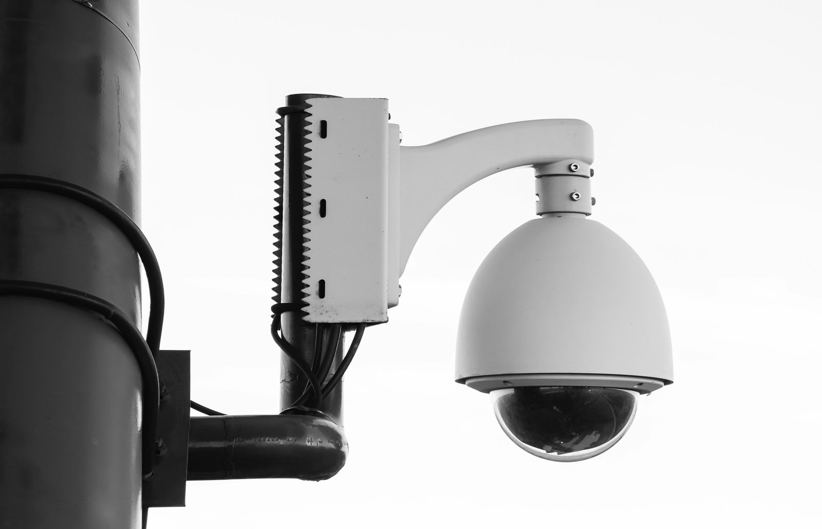 A dome security camera on a pole mount